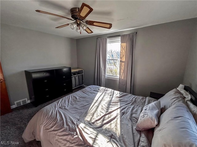 carpeted bedroom featuring baseboards, visible vents, and ceiling fan