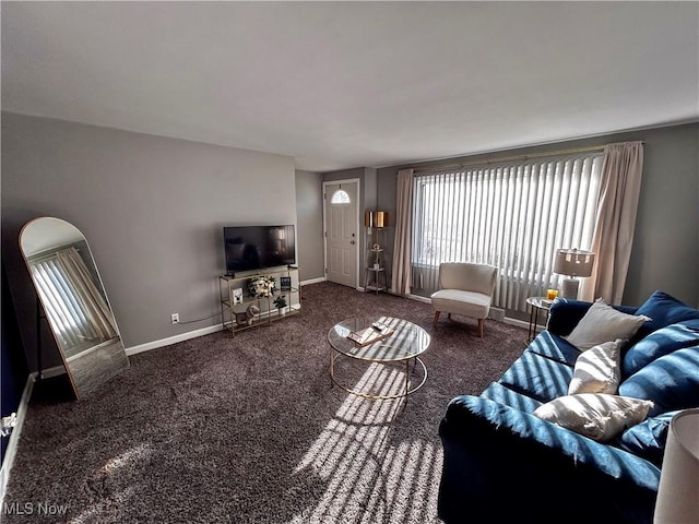 carpeted living area featuring baseboards