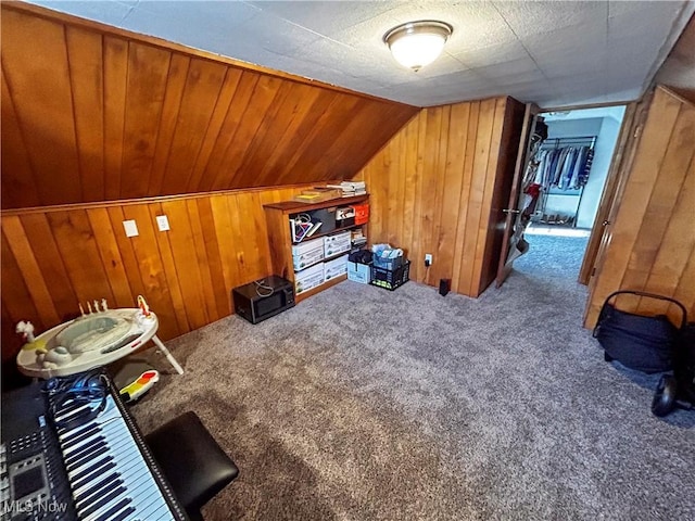 additional living space with carpet floors, wood walls, and vaulted ceiling