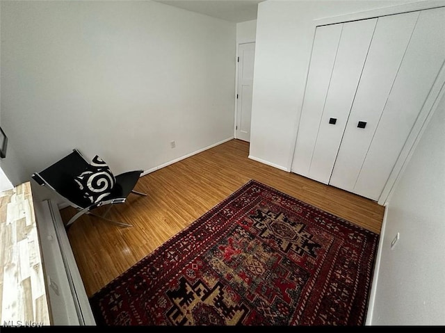 bedroom featuring baseboards and wood finished floors