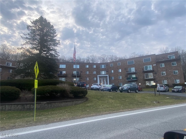 view of building exterior with uncovered parking