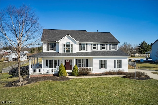 view of front facade with covered porch, a front yard, and a shingled roof