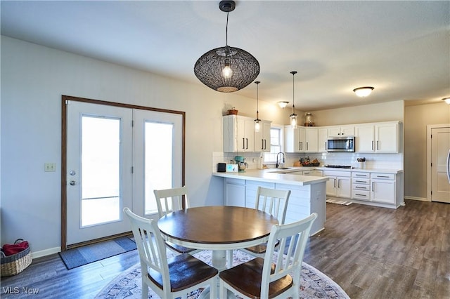 dining area featuring baseboards and dark wood-style flooring