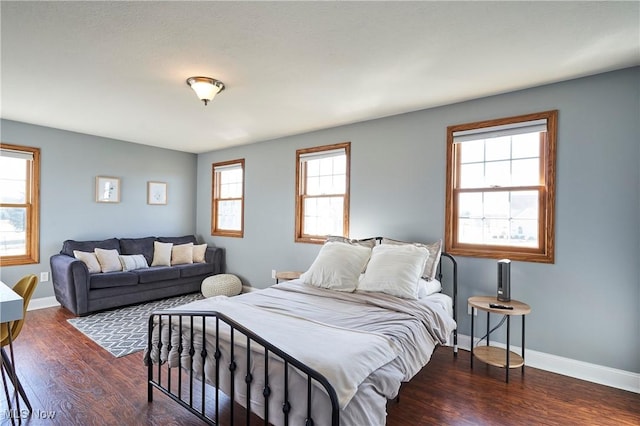 bedroom featuring baseboards and wood finished floors