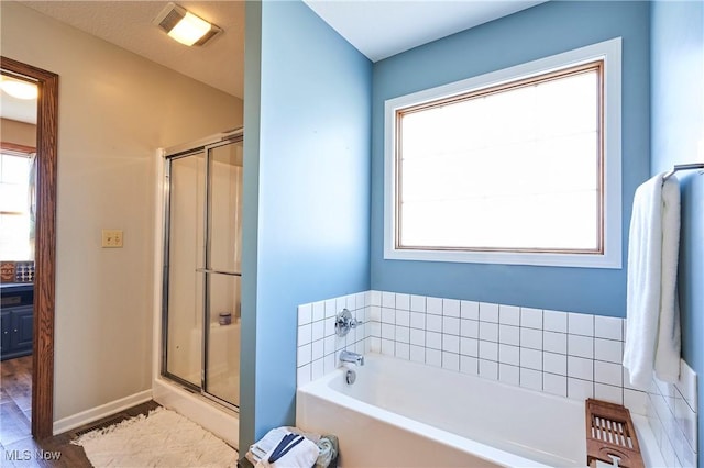 full bathroom with a shower stall, a bath, baseboards, and visible vents