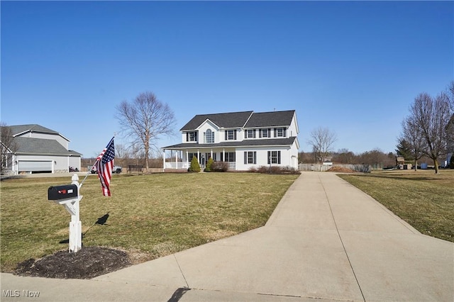 view of front of property with a porch, a front lawn, and driveway