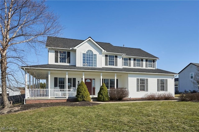 view of front of property featuring covered porch and a front lawn