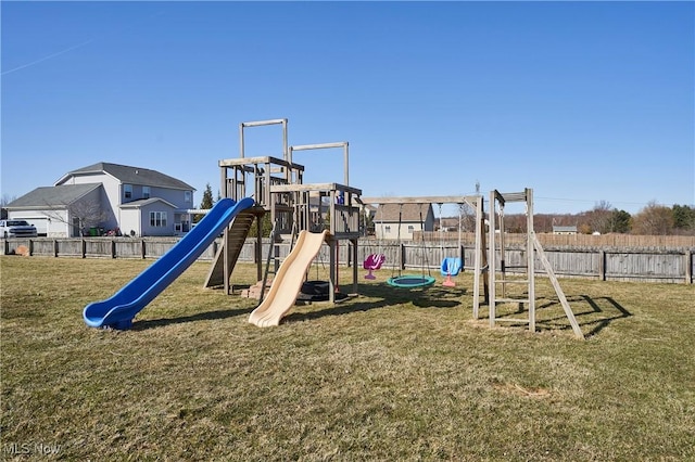 view of playground with a lawn and fence