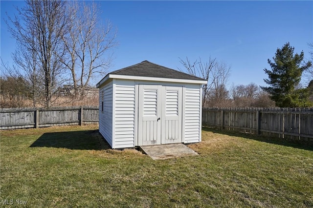 view of shed with a fenced backyard