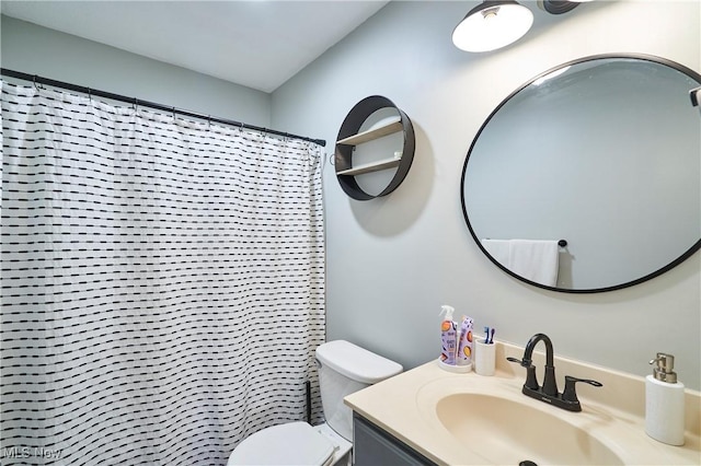 bathroom featuring curtained shower, toilet, and vanity