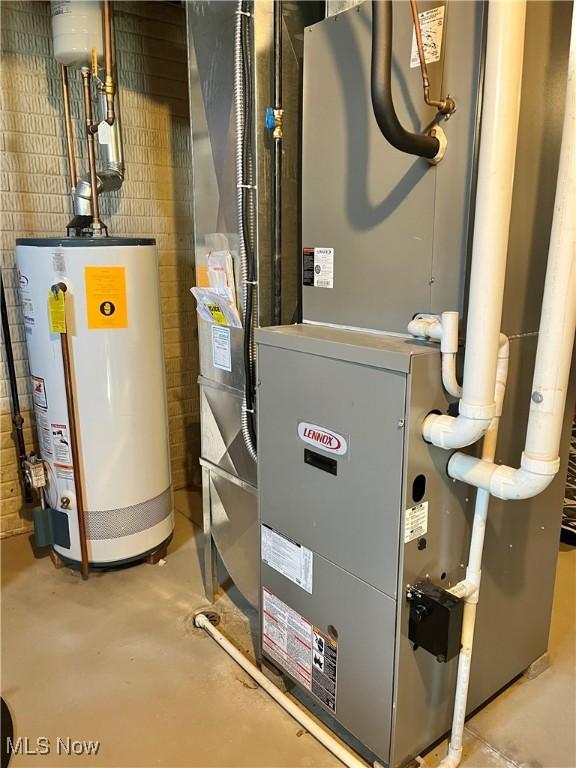 utility room with gas water heater and heating unit