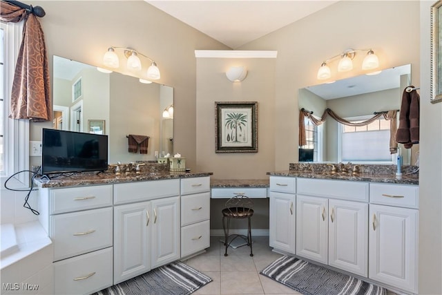 bathroom featuring tile patterned floors, visible vents, a sink, and two vanities