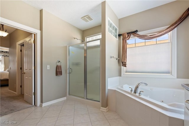 ensuite bathroom featuring visible vents, a shower stall, tile patterned floors, a jetted tub, and connected bathroom