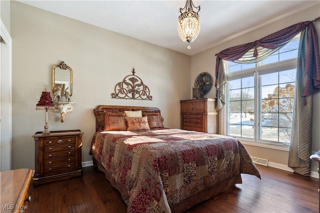 bedroom with visible vents, wood-type flooring, and baseboards