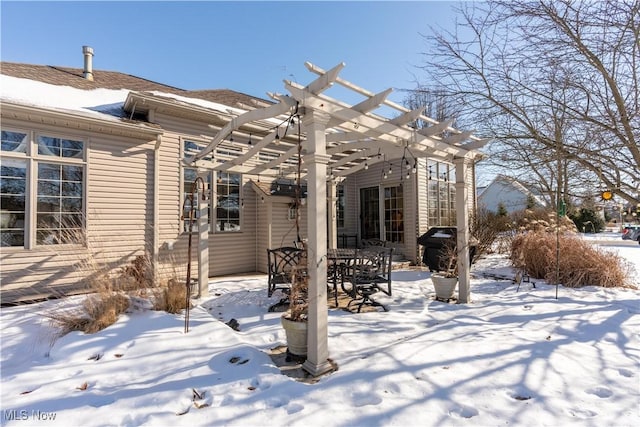 snow covered property featuring a patio and a pergola