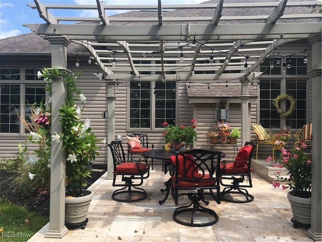 view of patio with outdoor dining space and a pergola