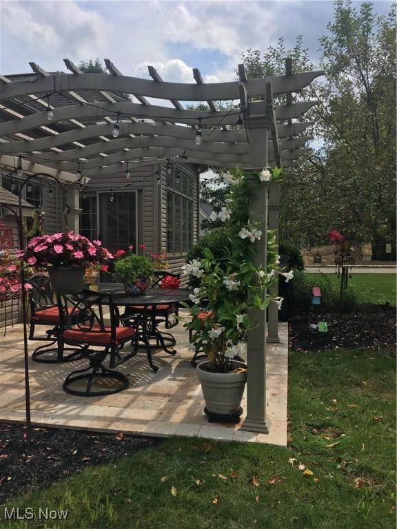 view of patio with outdoor dining area and a pergola