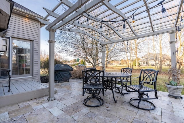 view of patio featuring outdoor dining area, a grill, and a pergola