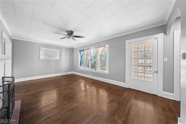 unfurnished living room with baseboards, a brick fireplace, dark wood-style floors, and ornamental molding