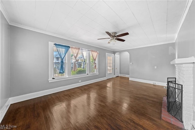 unfurnished living room featuring a ceiling fan, wood finished floors, baseboards, a fireplace, and arched walkways