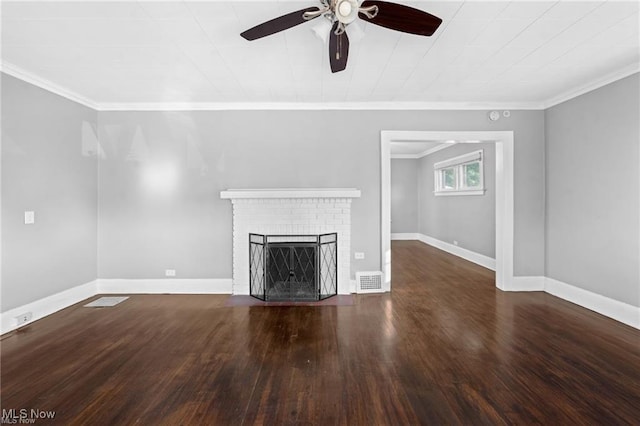 unfurnished living room featuring visible vents, wood finished floors, a fireplace, crown molding, and baseboards