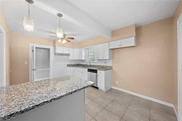 kitchen with light stone countertops, baseboards, white cabinets, dishwasher, and beamed ceiling