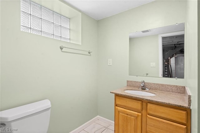 half bathroom with visible vents, baseboards, toilet, and vanity