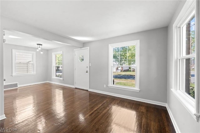 interior space featuring visible vents, a healthy amount of sunlight, and hardwood / wood-style flooring