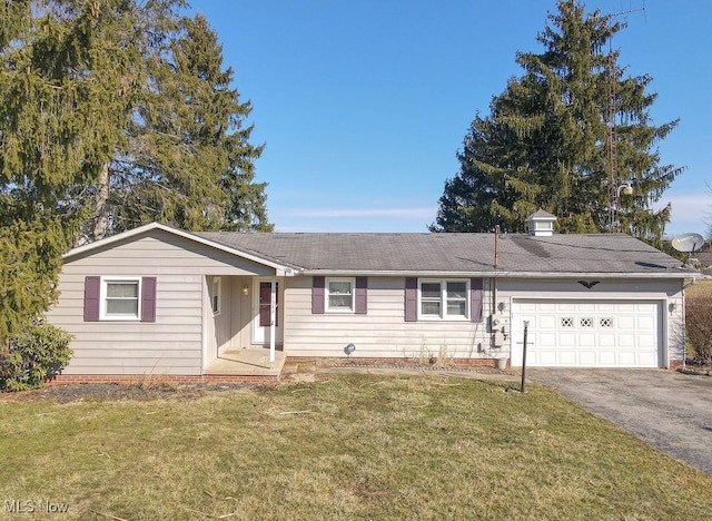 ranch-style home with a garage, driveway, and a front lawn