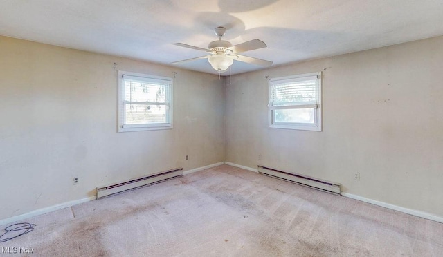 carpeted spare room with a baseboard heating unit, a wealth of natural light, baseboards, and baseboard heating