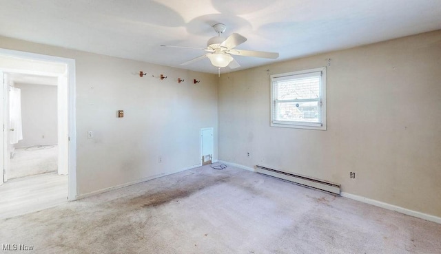 unfurnished room featuring baseboard heating, baseboards, a ceiling fan, and carpet floors