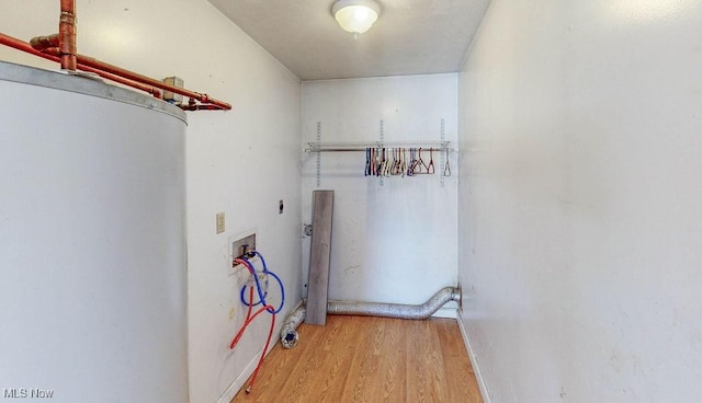 laundry area with electric dryer hookup, wood finished floors, hookup for a washing machine, and laundry area