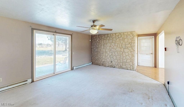 empty room with a textured ceiling, a ceiling fan, carpet, and a baseboard radiator