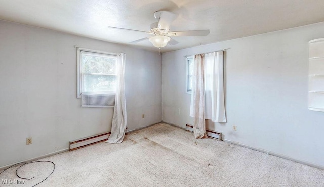 carpeted empty room with baseboards, baseboard heating, and a ceiling fan