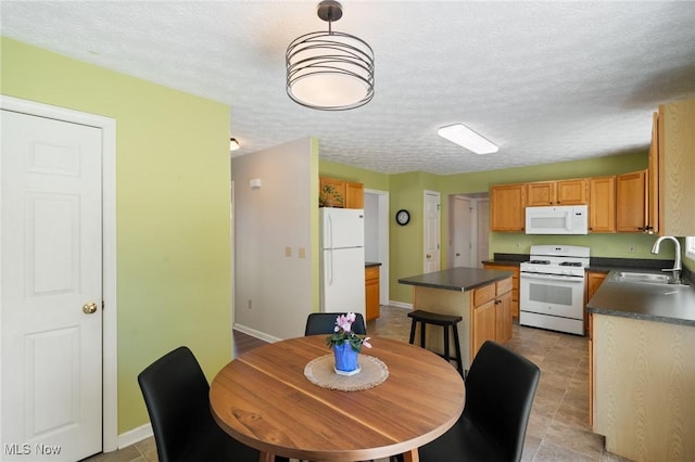 dining room featuring a textured ceiling and baseboards