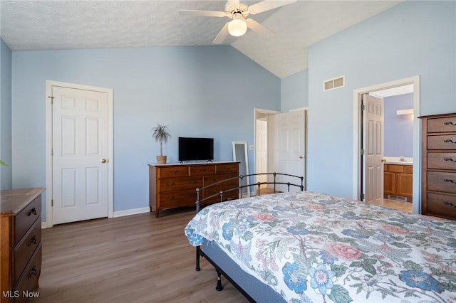 bedroom featuring visible vents, baseboards, ceiling fan, vaulted ceiling, and light wood-style floors