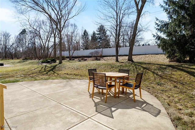 view of patio with outdoor dining space and fence