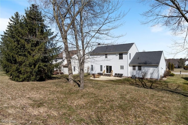 rear view of house with entry steps, a yard, and a patio area