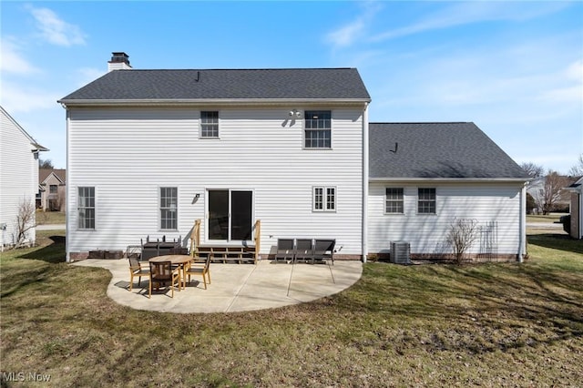 back of house with a yard, a chimney, and a patio