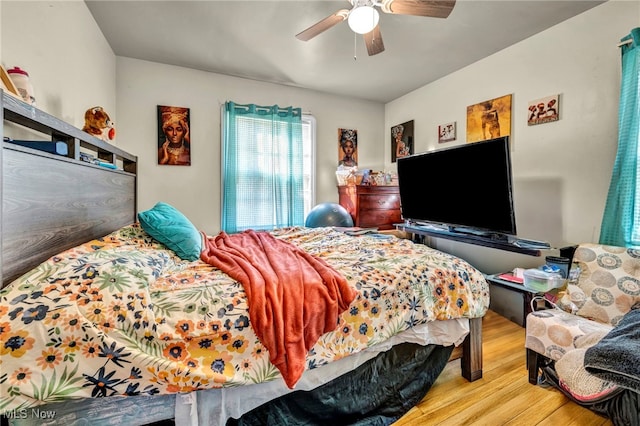 bedroom featuring a ceiling fan and wood finished floors