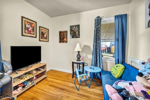 living room with baseboards and wood finished floors