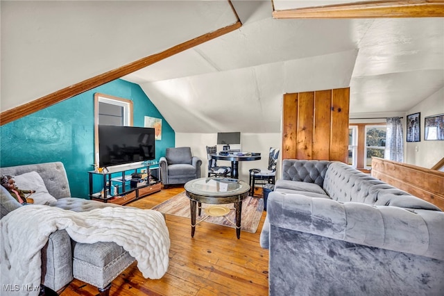 living room featuring hardwood / wood-style floors and vaulted ceiling