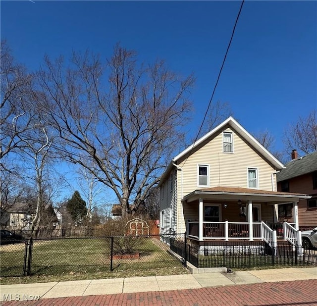 view of front of house with a fenced front yard and covered porch