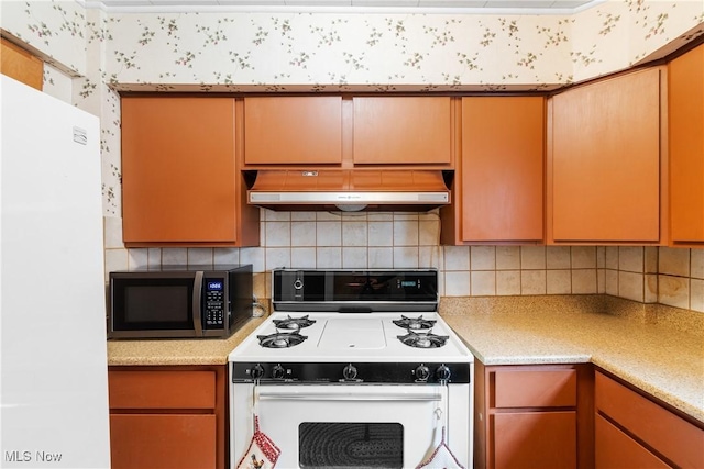 kitchen with backsplash, white appliances, ventilation hood, and light countertops