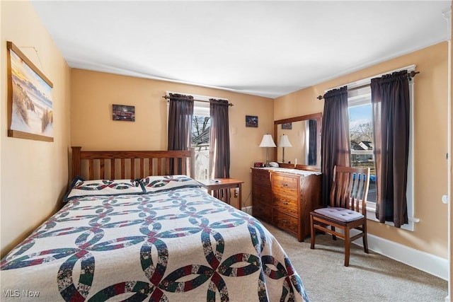 bedroom with baseboards and carpet