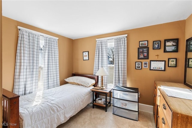 carpeted bedroom featuring baseboards