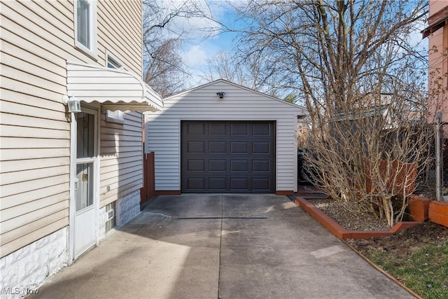 detached garage featuring driveway