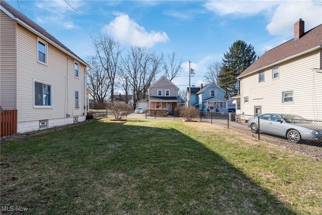 view of yard with fence and a residential view