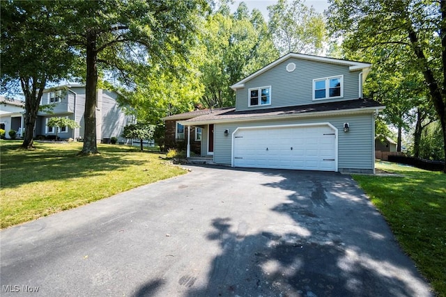 traditional-style home featuring an attached garage, driveway, and a front yard