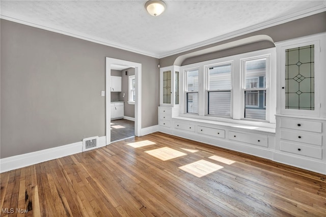 12117 Craven Ave, Cleveland, OH 44105 - spare room with baseboards, wood finished floors, crown molding, and a textured ceiling